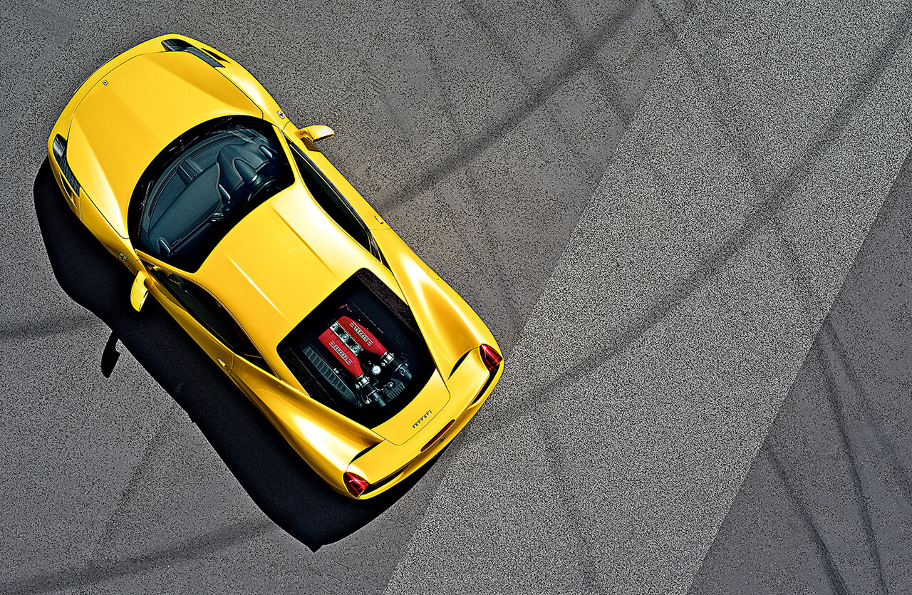 Birds Eye view of yellow Ferrari Racing Car with exposed engine